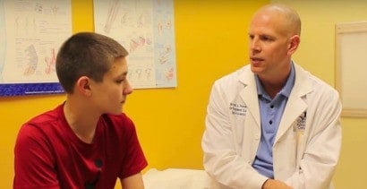 Jacob with Bryan L. Reuss, M.D., during a follow-up appointment for his broken arm.