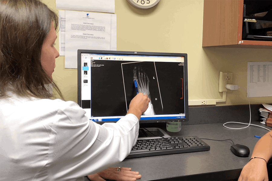 A specialist reviews an x-ray before Total Ankle Replacement Surgery