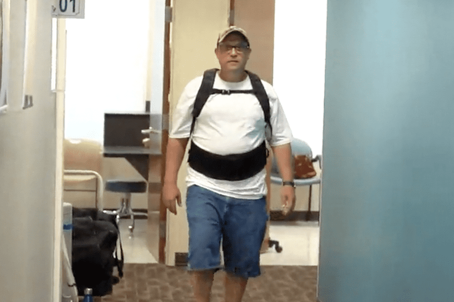 Back pain patient Tim G. walks after back surgery performed by Stephen R. Goll, M.D,, a board-certified orthopaedic surgeon at Orlando Orthopaedic Center.