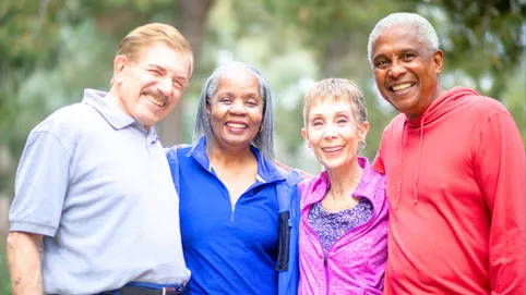 Four people smiling outdoors