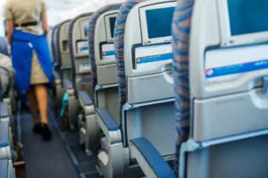 Airplane cabin showing the physical demands of a flight attendant job with hip pain